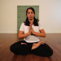 Young woman sitting doing pranayam meditation yoga | Santosh Yoga Institute in Salt Lake City, UT