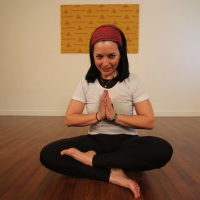 Young woman sitting doing pranayam meditation yoga | Santosh Yoga Institute in Salt Lake City, UT