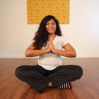 Young woman sitting doing meditation yoga | Santosh Yoga Institute in Salt Lake City, UT