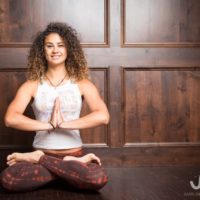 Young woman sitting doing meditation yoga | Santosh Yoga Institute in Salt Lake City, UT