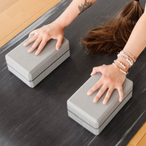 Woman doing exercise using 4in Foam Yoga Block in Salt Lake City, UT | Santosh Yoga Institute