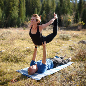 Flexible woman & man doing yoga exercise outdoors in Salt Lake City, UT | Santosh Yoga Institute