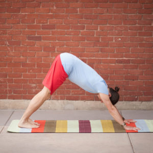 Woman doing yoga using Cotton Rug Yoga Mat in Salt Lake City, UT | Santosh Yoga Institute