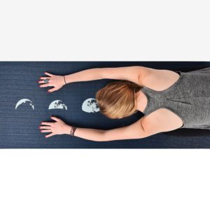Woman doing yoga on the ultra yoga blue moon mat in Salt Lake City, UT | Santosh Yoga Institute