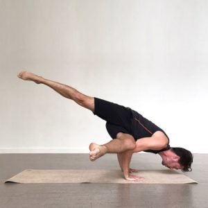 Flexible Man Doing Yoga Using Sattva Jute Yoga Mat in Salt Lake City, UT | Santosh Yoga Institute