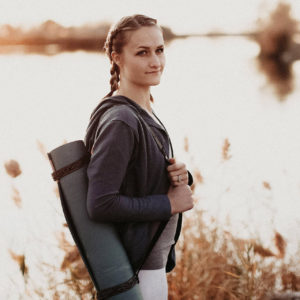 Woman Carrying Simple Sling Yoga Mat Carrier in Salt Lake City, UT | Santosh Yoga Institute