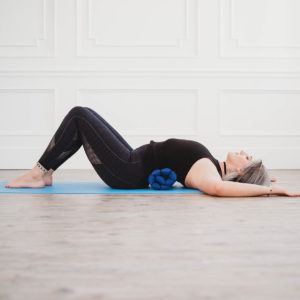 Young woman doing yoga using Zafuko Rollable Yoga & Meditation Cushion in Salt Lake City, UT | Santosh Yoga Institute
