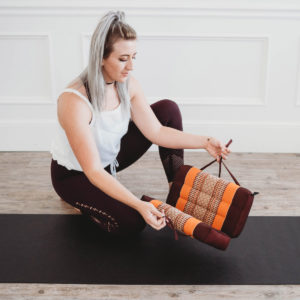 Young Girl Opening Zafuko Large Foldable Yoga & Meditation Cushion in Salt Lake City, UT | Santosh Yoga Institute