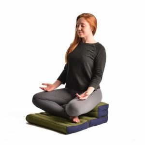 Young girl sitting on a double foldable meditation cushion in Salt Lake City, UT | Santosh Yoga Institute