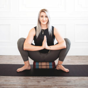 Young doing yoga sitting on Zafuko Yoga & Meditation Cushion in Salt Lake City, UT | Santosh Yoga Institute