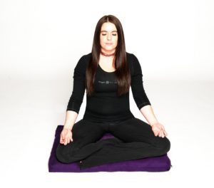 Woman doing yoga sitting on Zabuton Meditation Pillow in Salt Lake City, UT | Santosh Yoga Institute