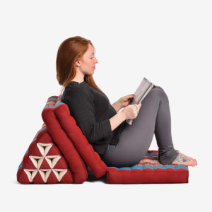 Young girl sitting on Zafuko Three Fold Thai Cushion in Salt Lake City, UT | Santosh Yoga Institute